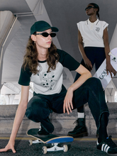 a lady wears a white raglan sleeve T-shirt and a lady wears a white polo shirt